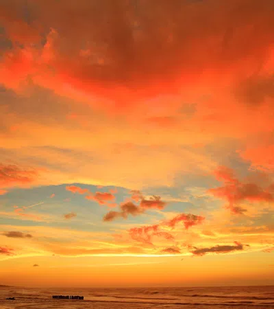 a colorful sky over a beach