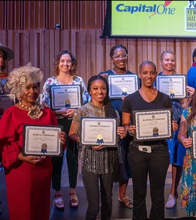 a group of people holding certificates