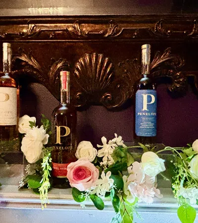 a table with bottles of wine and flowers
