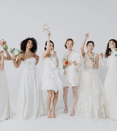 a group of women in white dresses