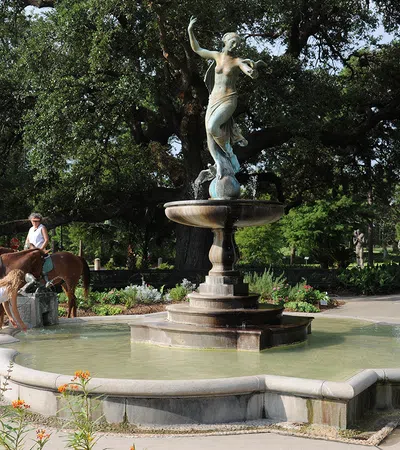 a person riding a horse in a fountain