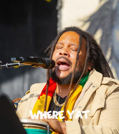 Stephen Marley with a beard singing into a microphone
