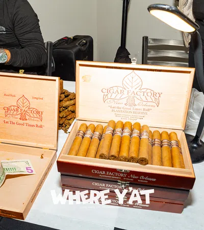 Cigar Factory display with premium cigars and cash on a table, showcasing the art of cigar crafting.