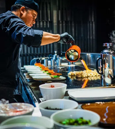 a person cooking food in a kitchen