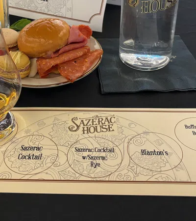 a table with plates of food and glasses of beer