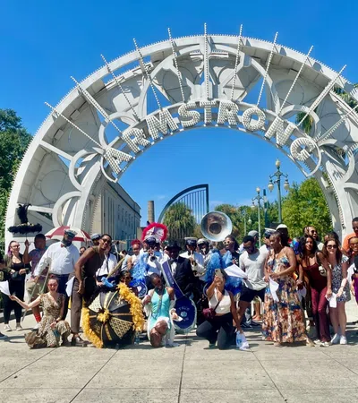a group of people posing for a photo in front of a large structure