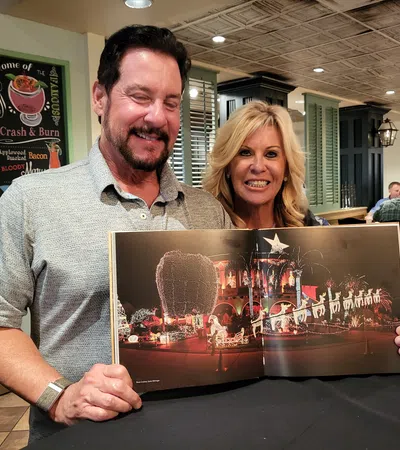 a man and a woman holding a framed picture