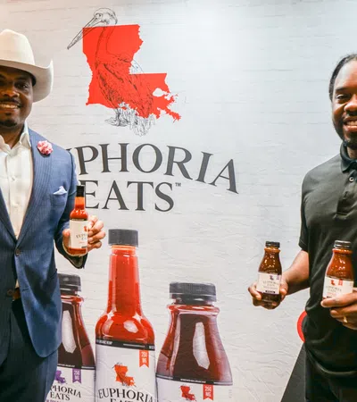 a couple of men holding bottles of alcohol