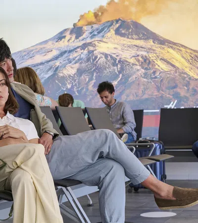 Aubrey Plaza et al. sitting in chairs with laptops