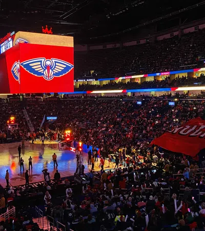 a basketball court with a crowd of people in the stands