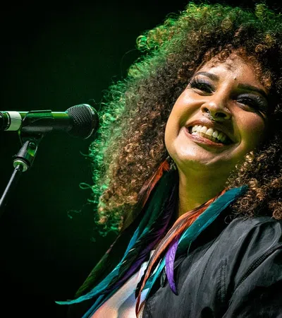 a man with curly hair smiling