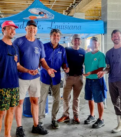 Group of fishermen showcasing their catch under a tent in Louisiana.