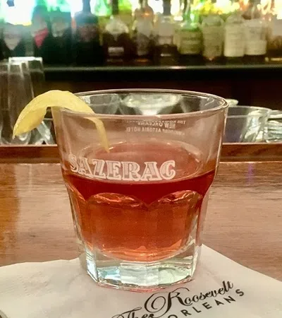 a glass of beer on a bar