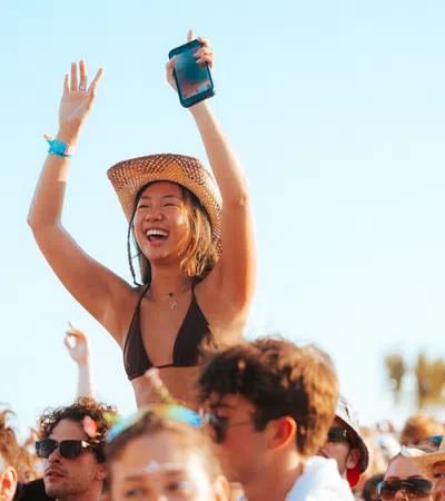 a person with a hat and a crowd of people