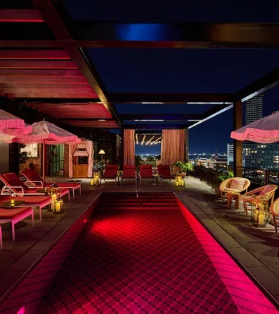 a red and white lounge area with pink umbrellas