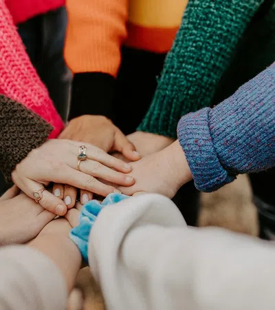 a close-up of people holding hands