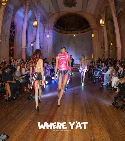 a group of women walking down a hall with people sitting on the floor
