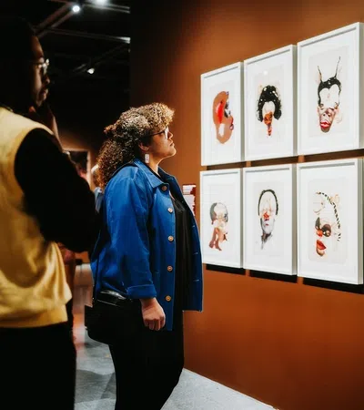 a man and woman looking at art