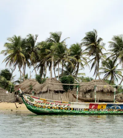 a boat with straw roofs on a beach