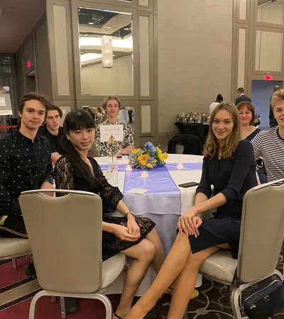 a group of people sitting around a table