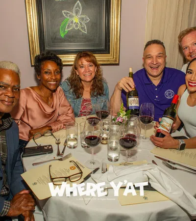 Billy Ceravolo et al. sitting around a table with wine glasses