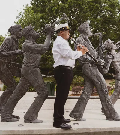 a person standing next to a statue