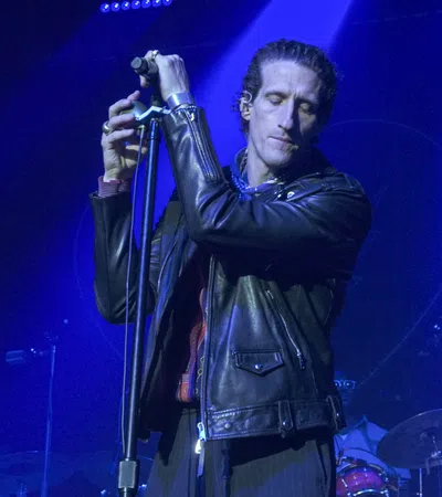 Joe Volpe holding a microphone