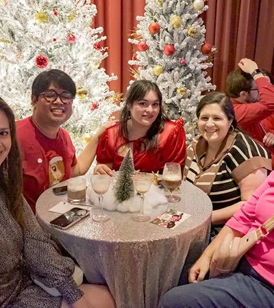 Pauleen Luna et al. sitting around a table with food and drinks