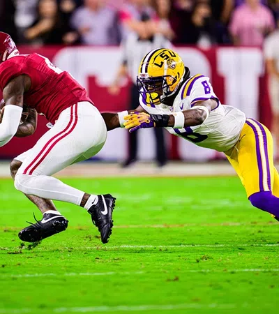 a football player tackling another football player