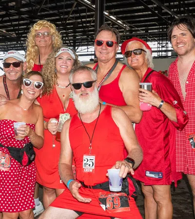 a group of people wearing red dresses