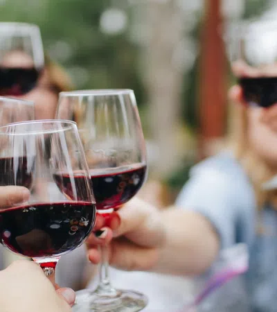 a group of people holding wine glasses