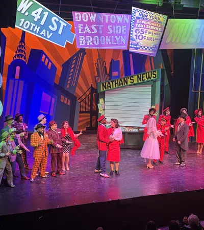 Colorful theatrical performance with actors in vintage costumes on a vibrant New York city themed stage.