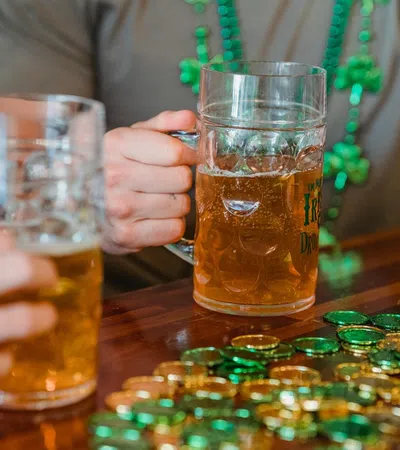 a group of people holding glasses of beer