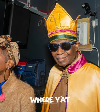 a man and woman wearing colorful hats
