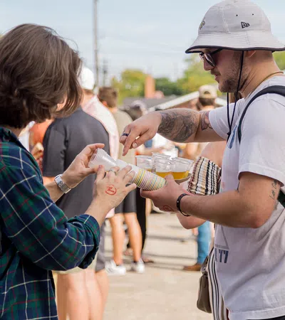 a man and woman holding a container of food