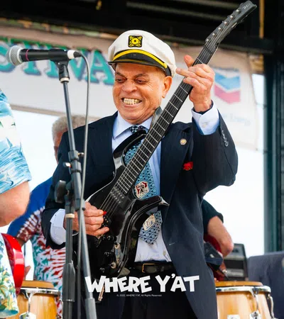 Deacon John Moore playing a guitar