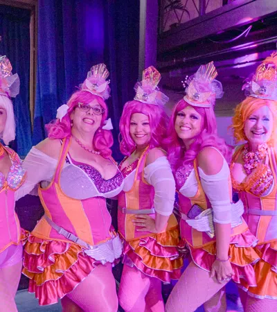 a group of women wearing pink and white clothing