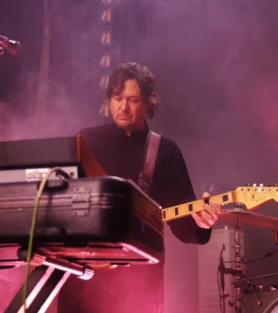 a man playing a guitar on a stage