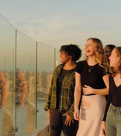 a group of people standing in front of a glass wall