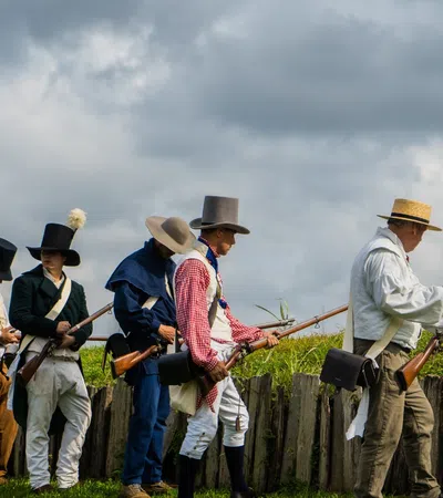 a group of people in cowboy hats holding guns
