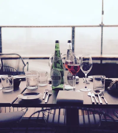 a table with wine glasses and bottles