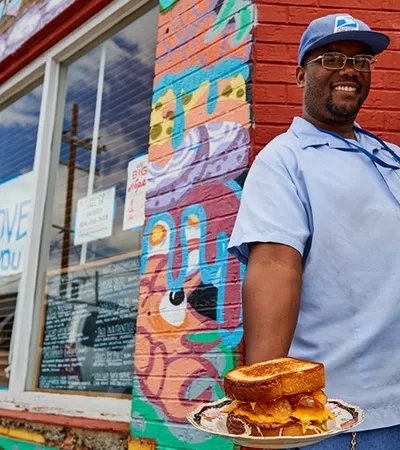 a person holding a plate of food