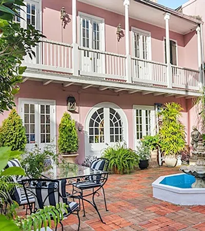 a courtyard with a fountain and chairs
