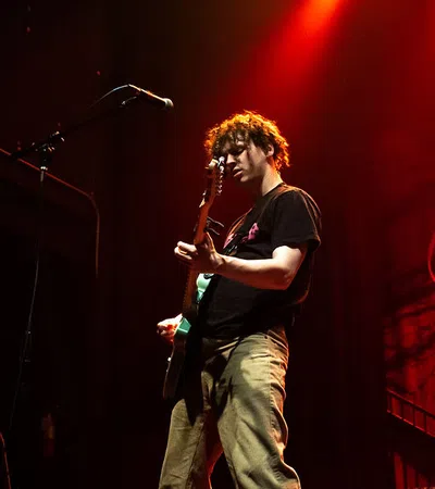 a man playing a guitar on a stage