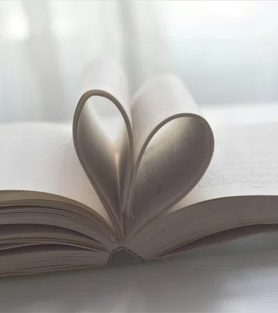 a pair of scissors on top of a stack of books
