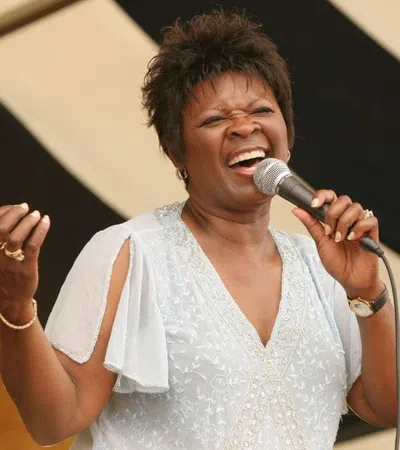 Irma Thomas singing into a microphone