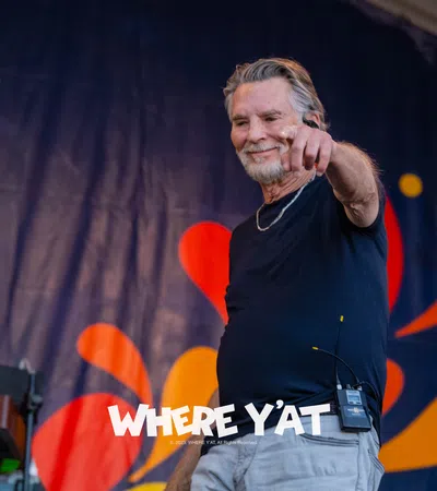 Kenny Loggins holding a microphone
