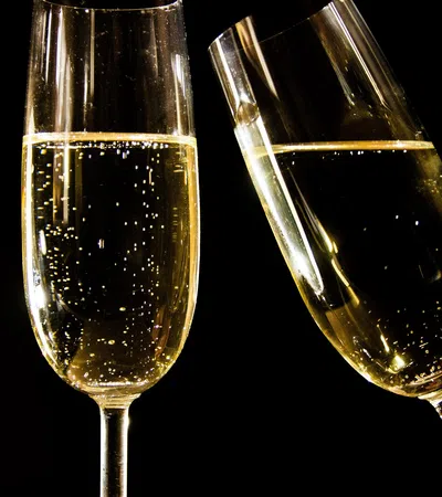 two wine glasses with white liquid