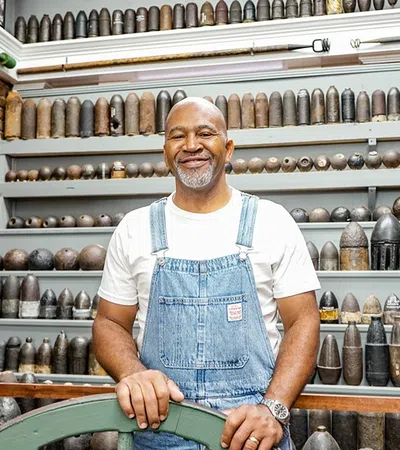 a man standing in front of a shelf of jars