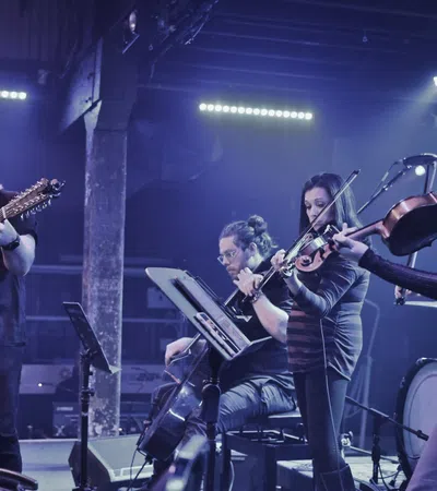 a group of people playing instruments on a stage